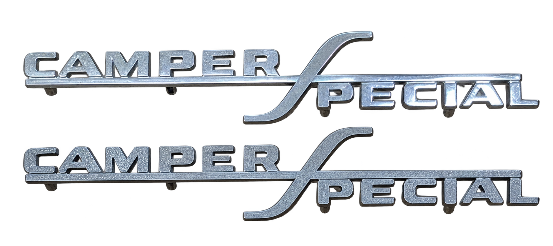 Two metallic reproduction Camper Special vehicle emblems