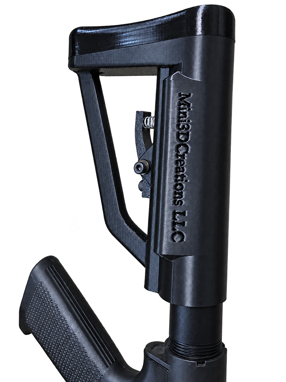 Black printed mechanical prototype with an open frame and spring-loaded trigger
